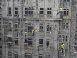 A serene Bali villa under renovation with workers and scaffolding.