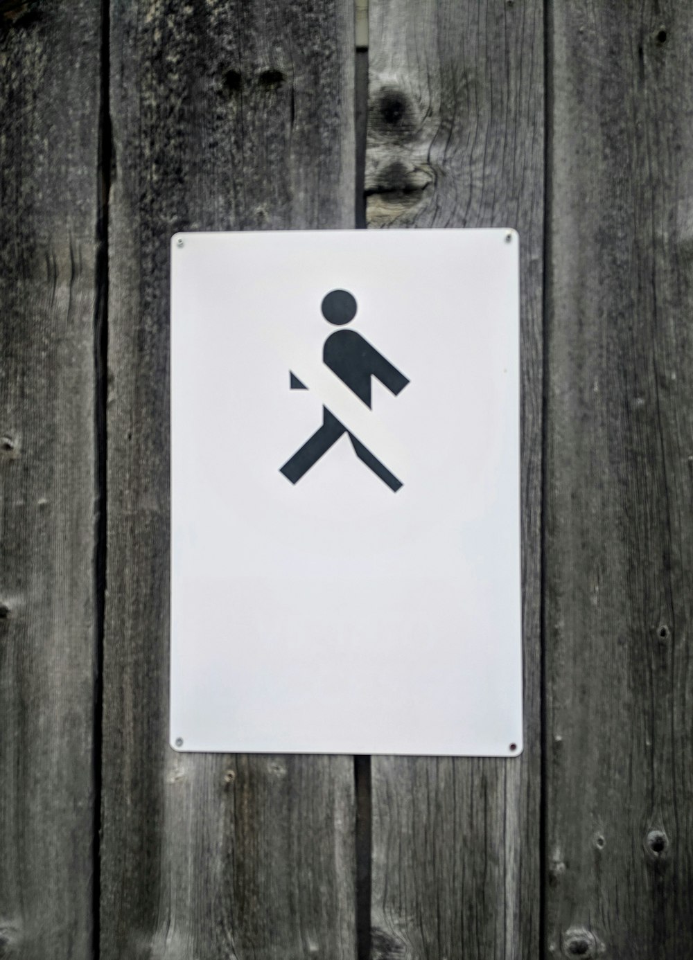 No Walking sign on gray wooden wall