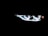 Brightly illuminated LED headlights with a modern, sleek design visible in the darkness, emphasizing a futuristic and high-tech aesthetic.