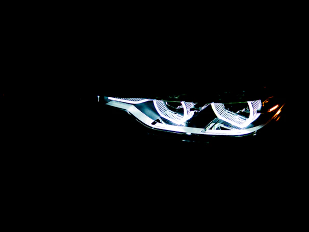 Bright automotive LED headlights glowing brightly in a dark setting