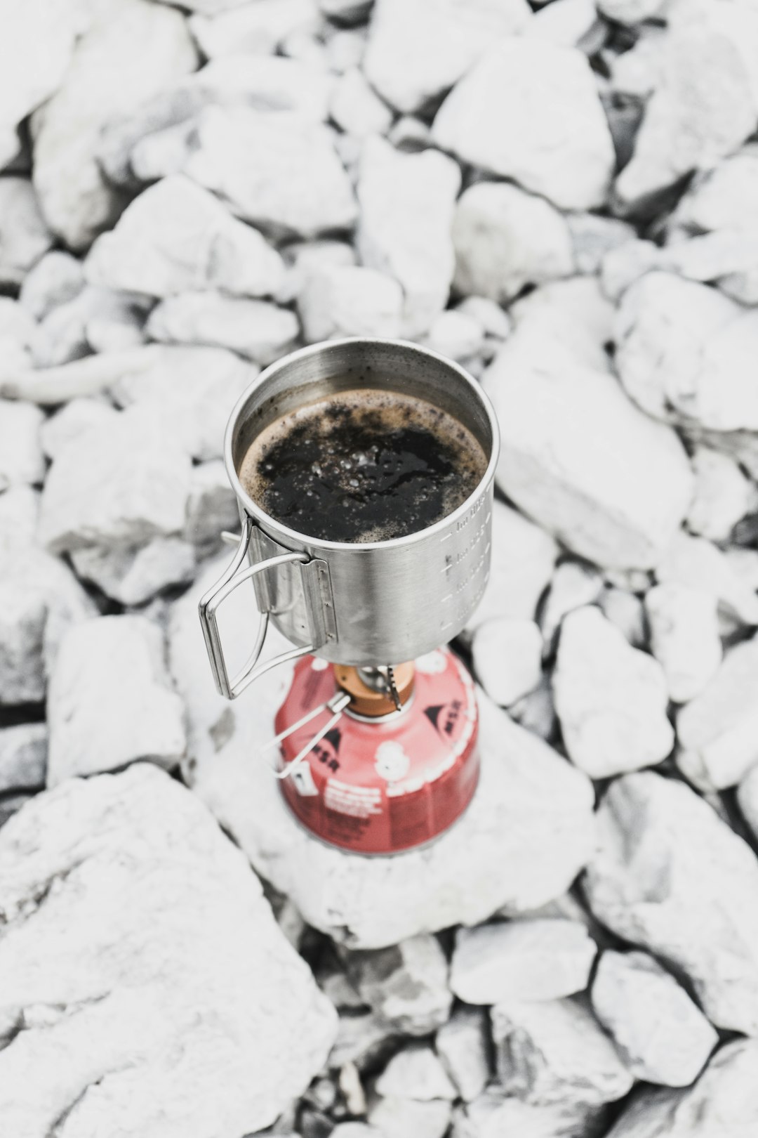 gray steel mug on red portable stove