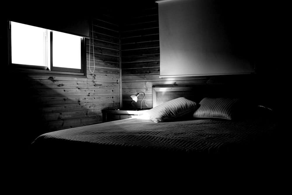 grayscale photography of empty bed