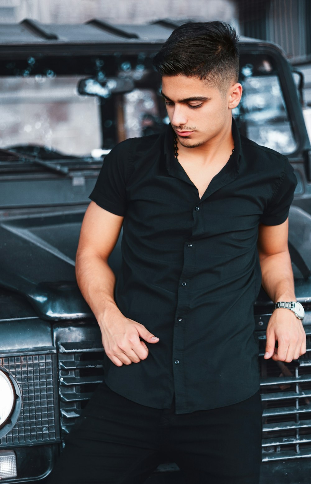 man leaning front of car