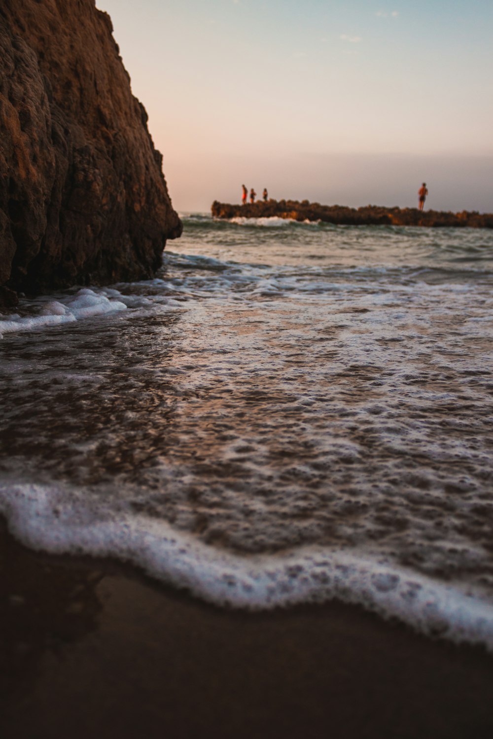 brown cliff beside ocean