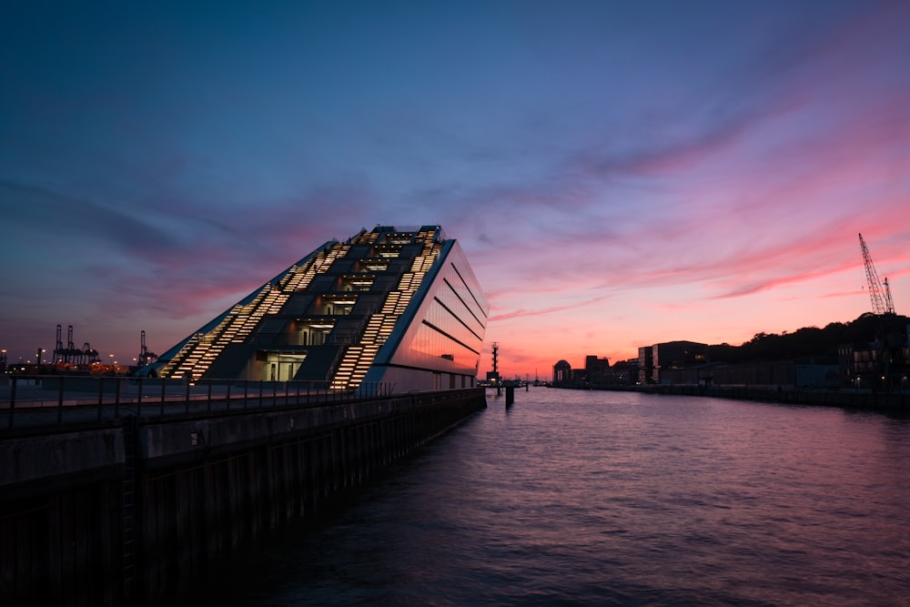 multi-story building beside body of water during golden hour