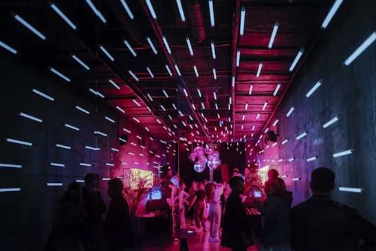 a group of people standing around in a room