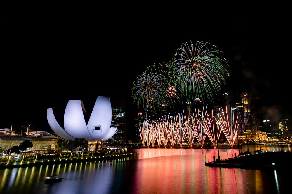 fireworks over fountains at night