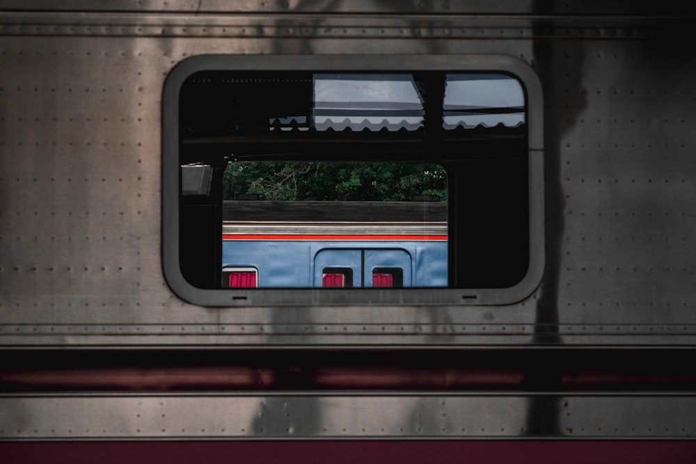 photo of gray and red train window frame