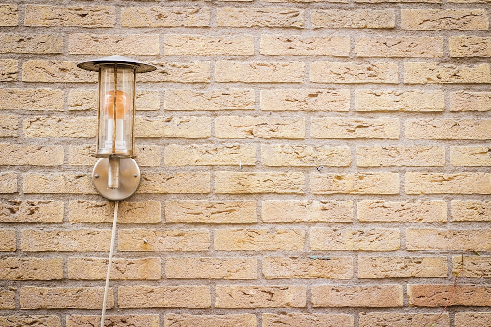 sconce lamp on brick wall