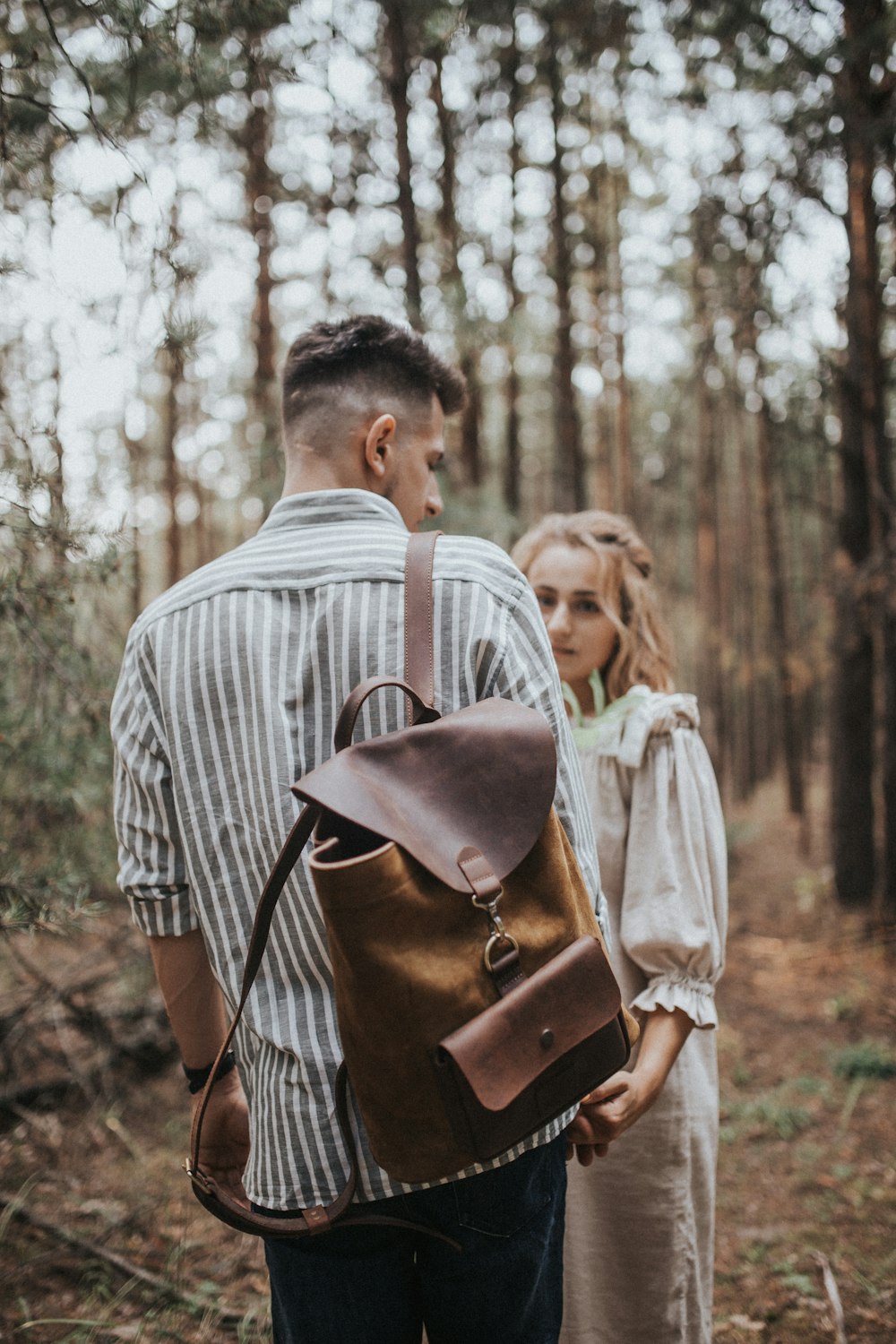 man standing in front of woman