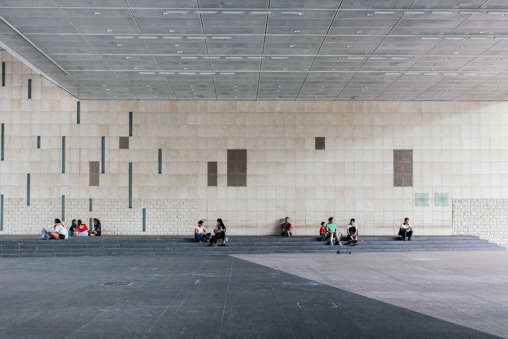 people sitting under overpass