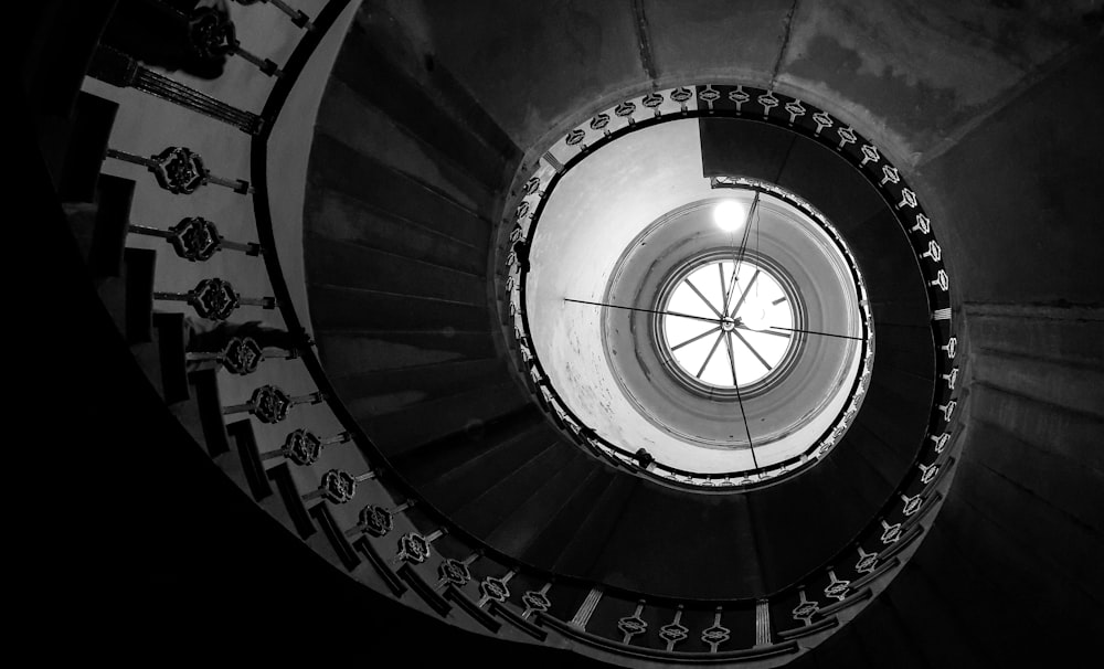 a black and white photo of a spiral staircase