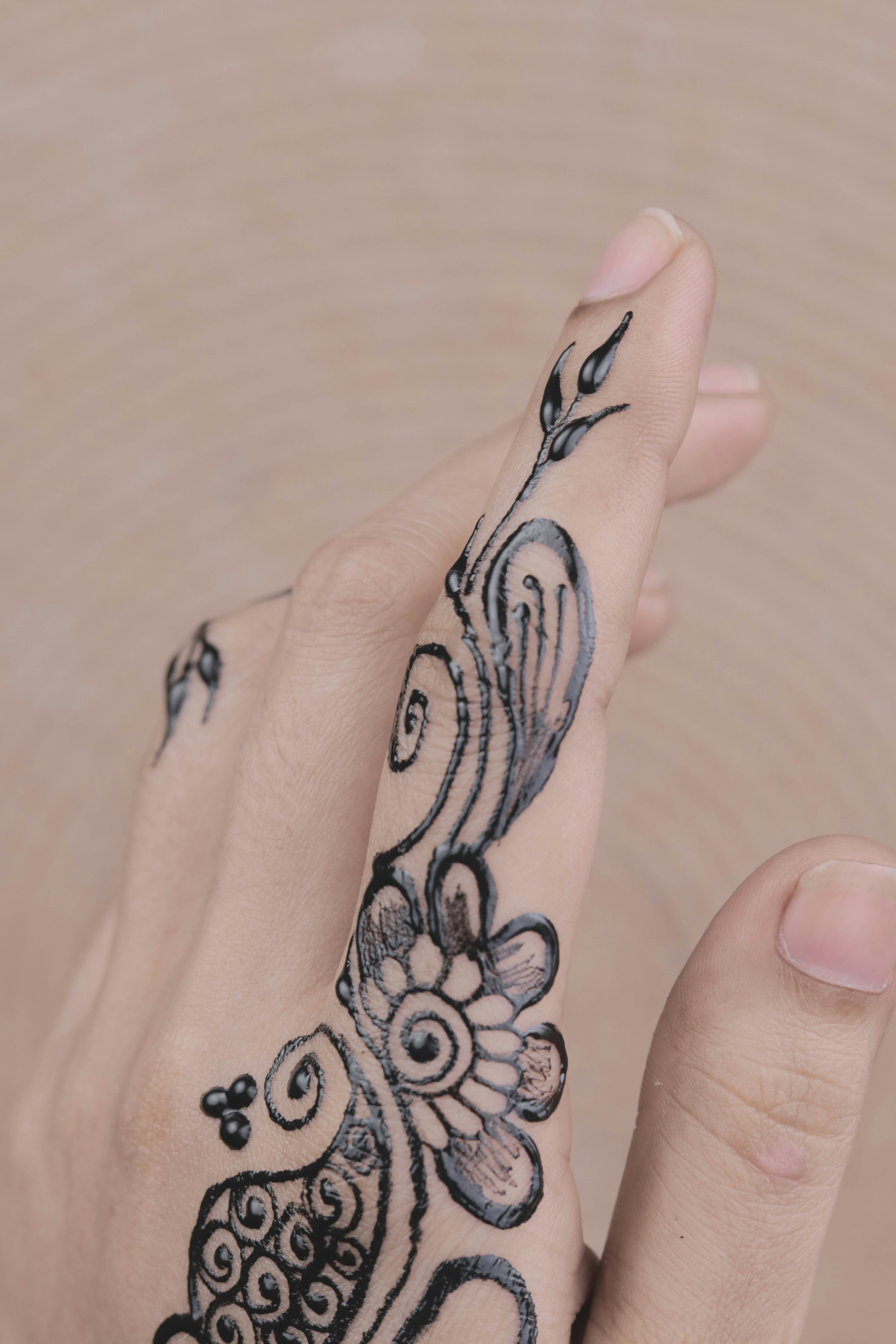 a woman's hand with a tattoo on it