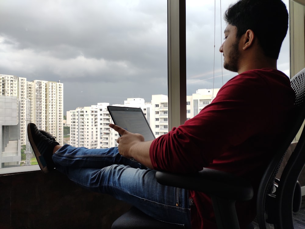 man sitting beside window