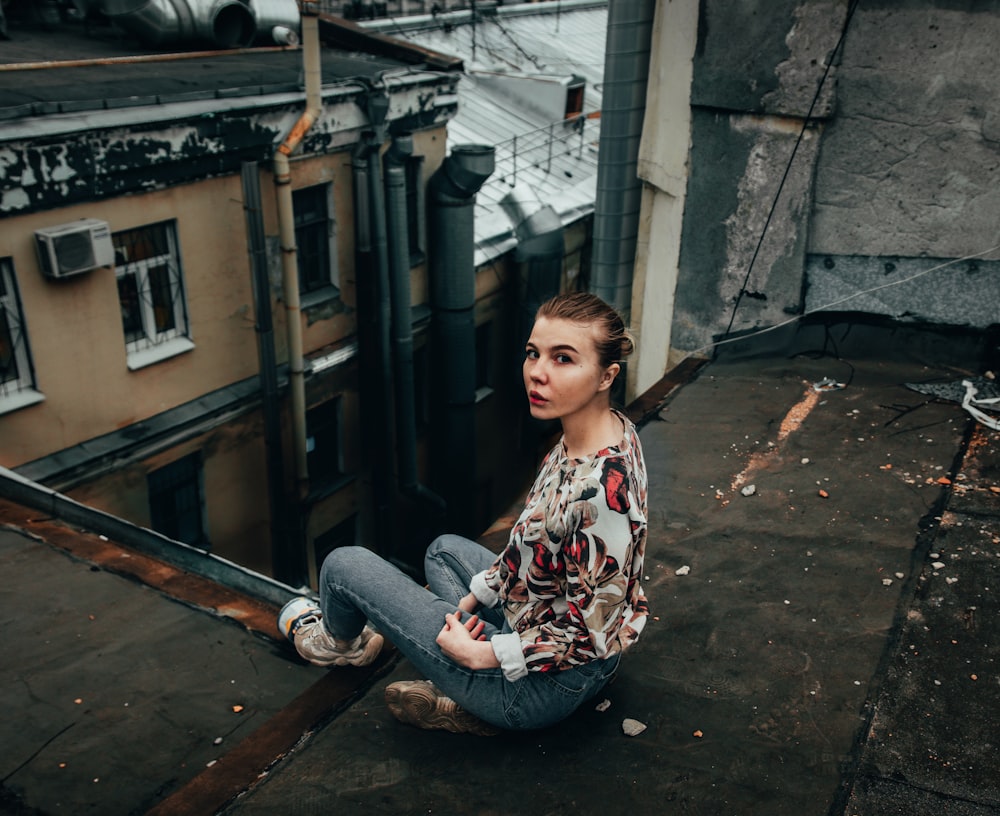 woman in floral blouse and blue jeans