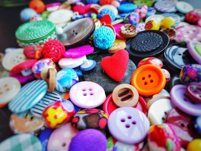 Close-up image of assorted buttons and ribbons displayed in a craft store.
