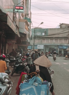 A vibrant street scene in Hanoi with locals cycling and colorful markets.