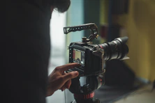 person pointing on DSLR camera screen