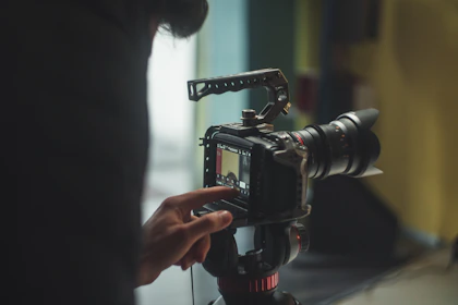 person pointing on DSLR camera screen