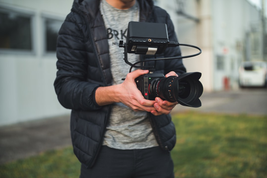 person holding DSLR camera