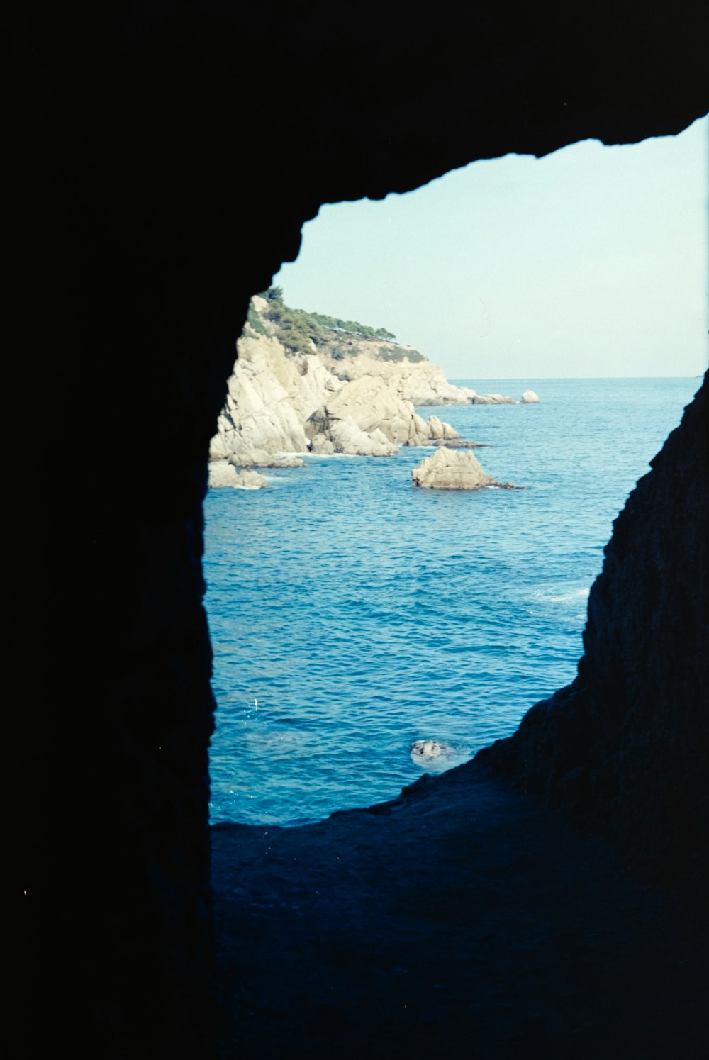a view of a body of water from a cave