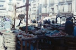 A vibrant local market scene showing fresh produce and community interaction in Sabah.