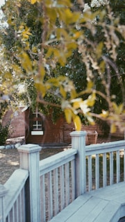 A beautifully crafted wooden fence surrounding a lush garden.