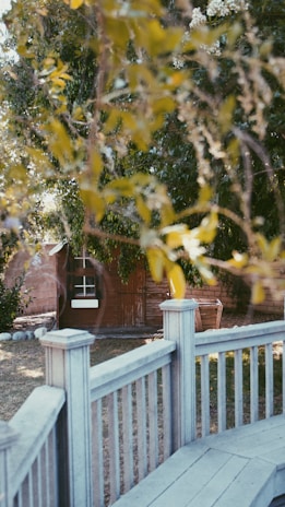 A beautifully crafted wooden fence surrounding a lush garden.