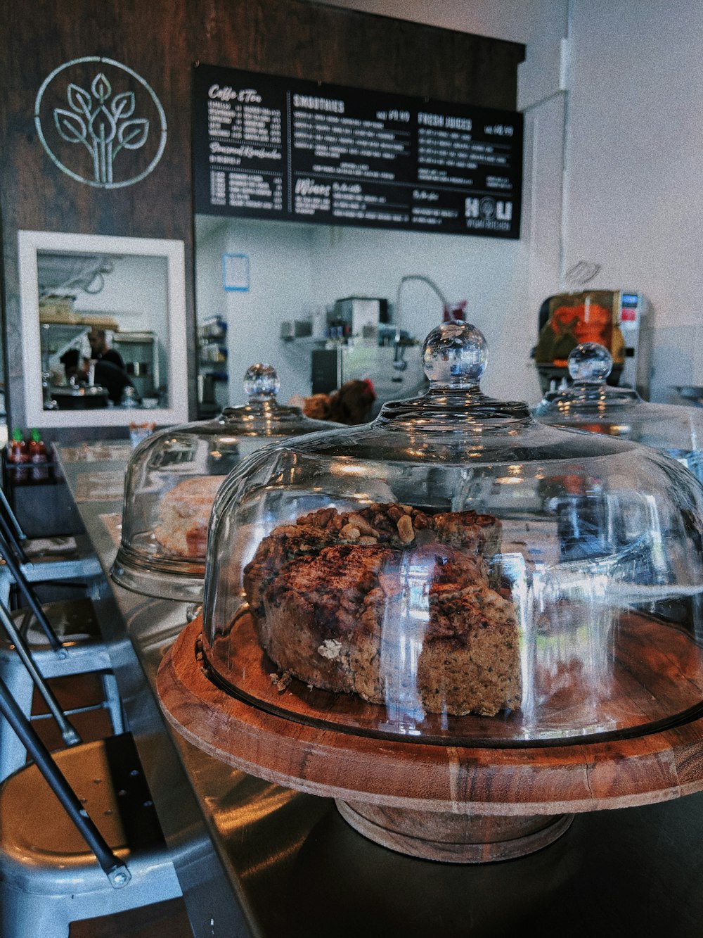 coffee shop sells two cakes inside dome glasses