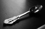 Argentia silverware clip displayed on a modern kitchen counter with natural light highlighting its sleek design.