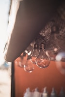 A minimalist grid layout displaying warm amber LED bulbs casting a gentle glow on a clean white surface.