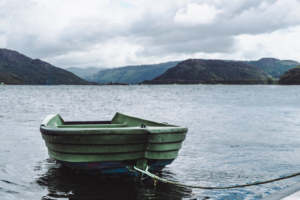 green boat on body of wate