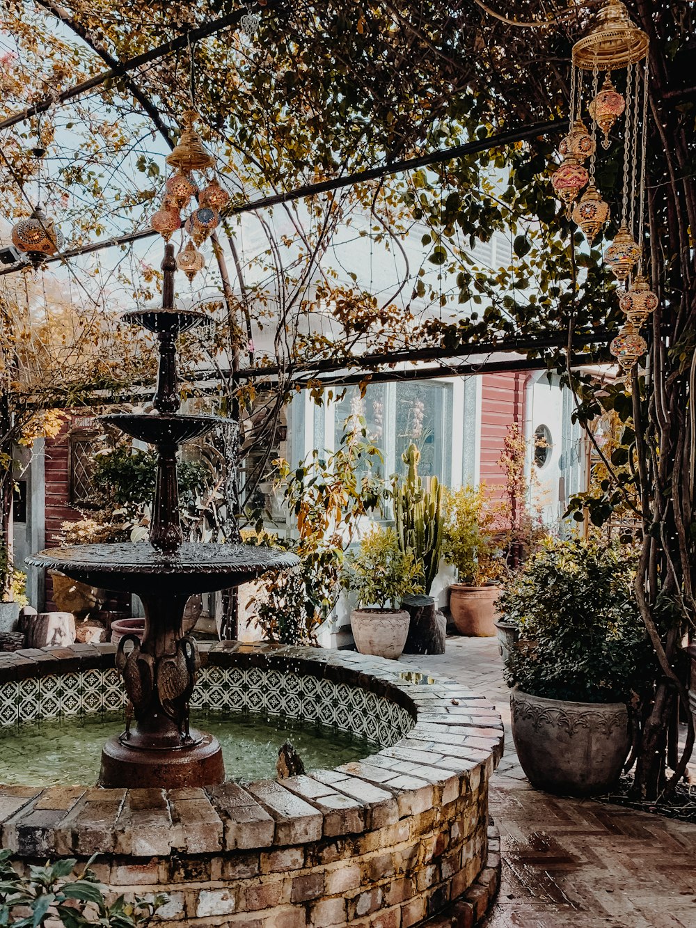 brown fountain beside tree