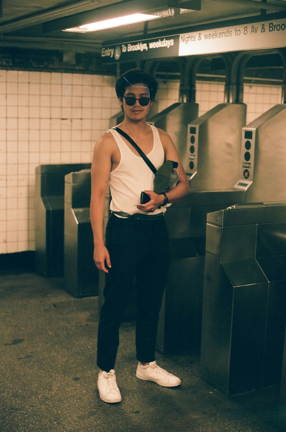 man in white tank and black pants