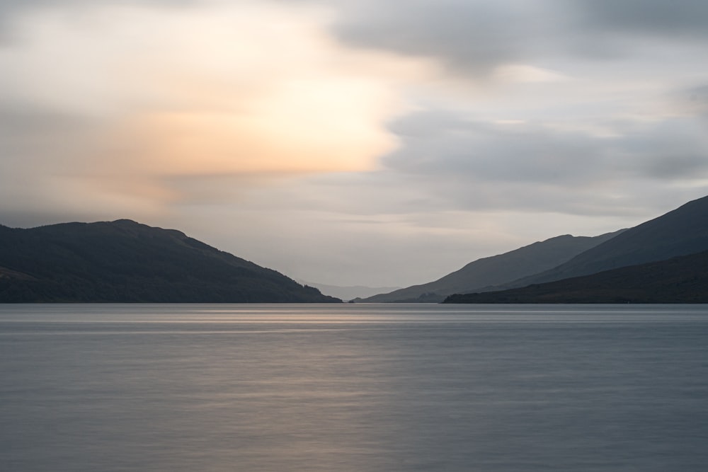 body of water under cloudy sky