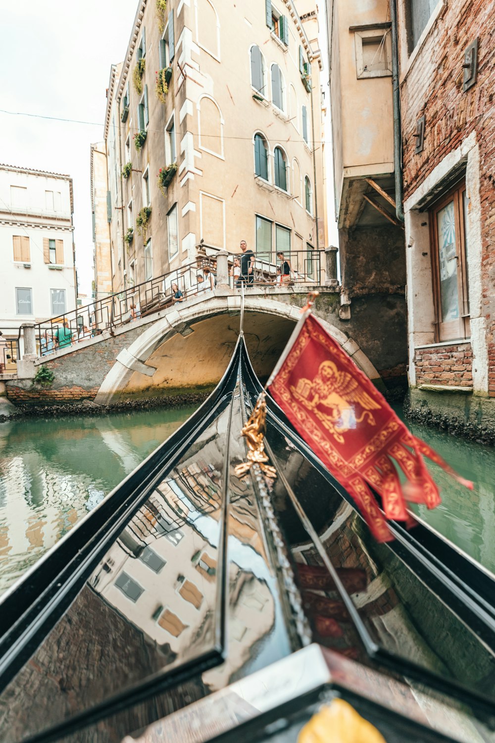 boat on calm body of water near buildings