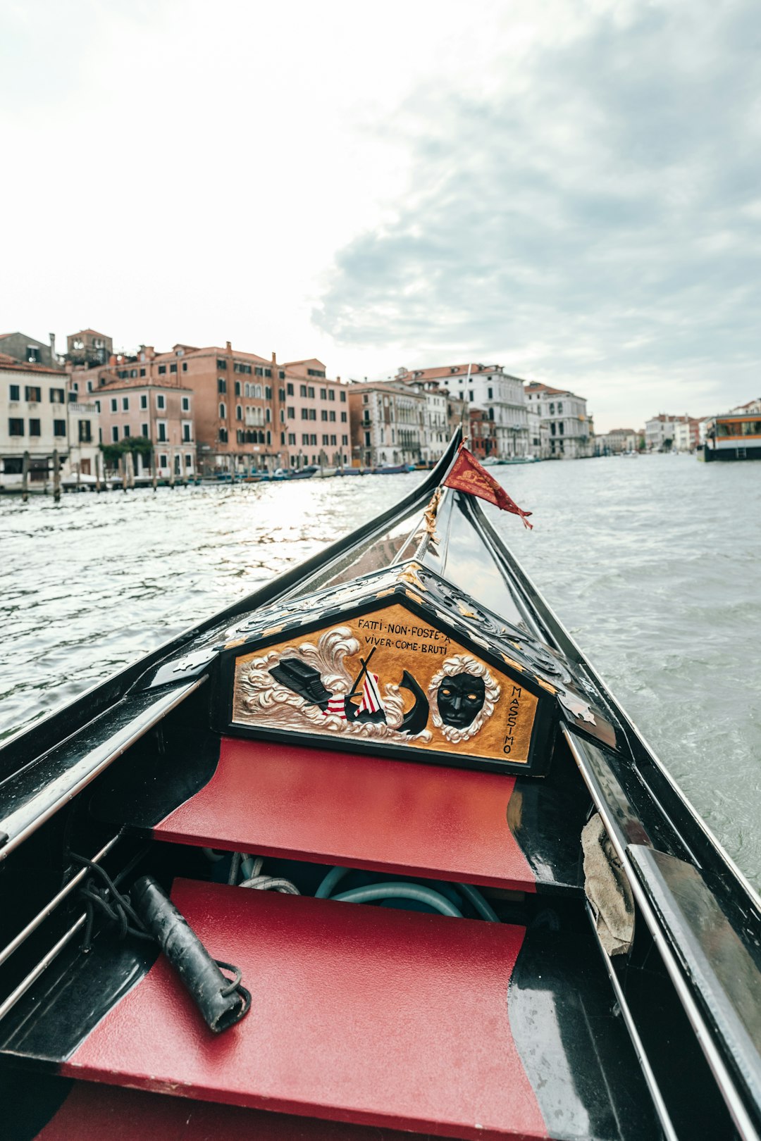 black and red wooden boat on body of water