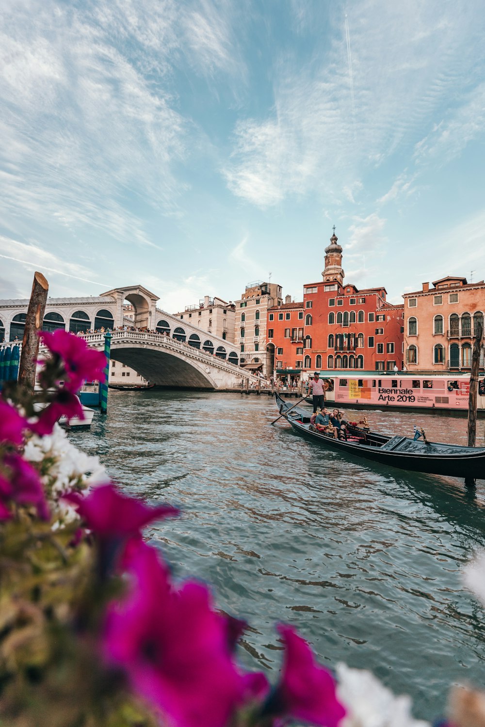 boat on body of water near buildings at daytime