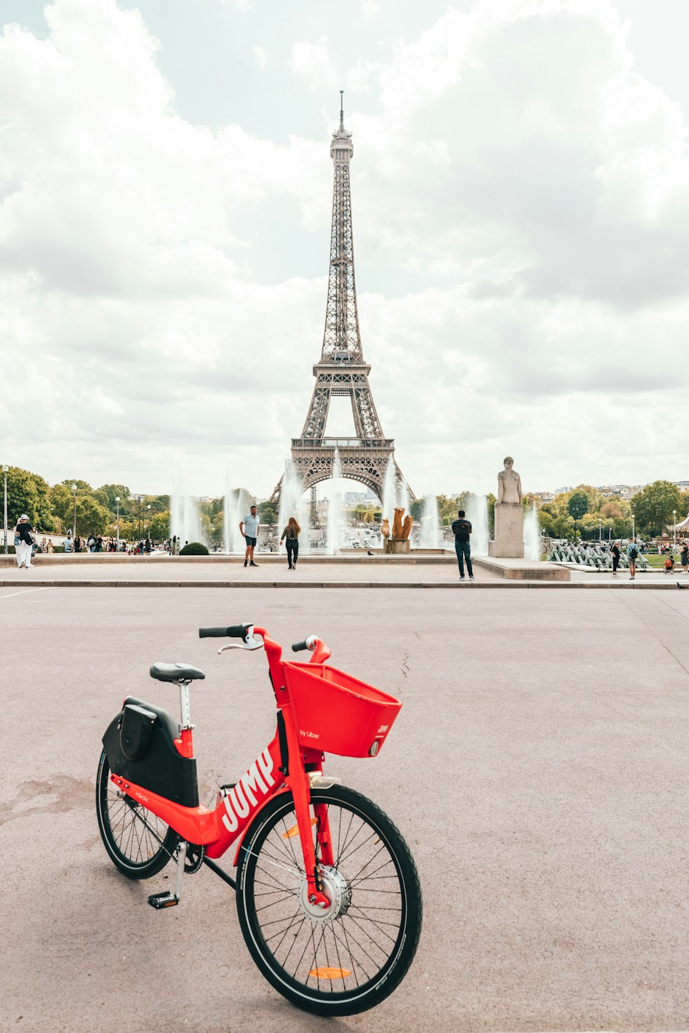 bicycle parked in an open area with Eiffel Tower in the background