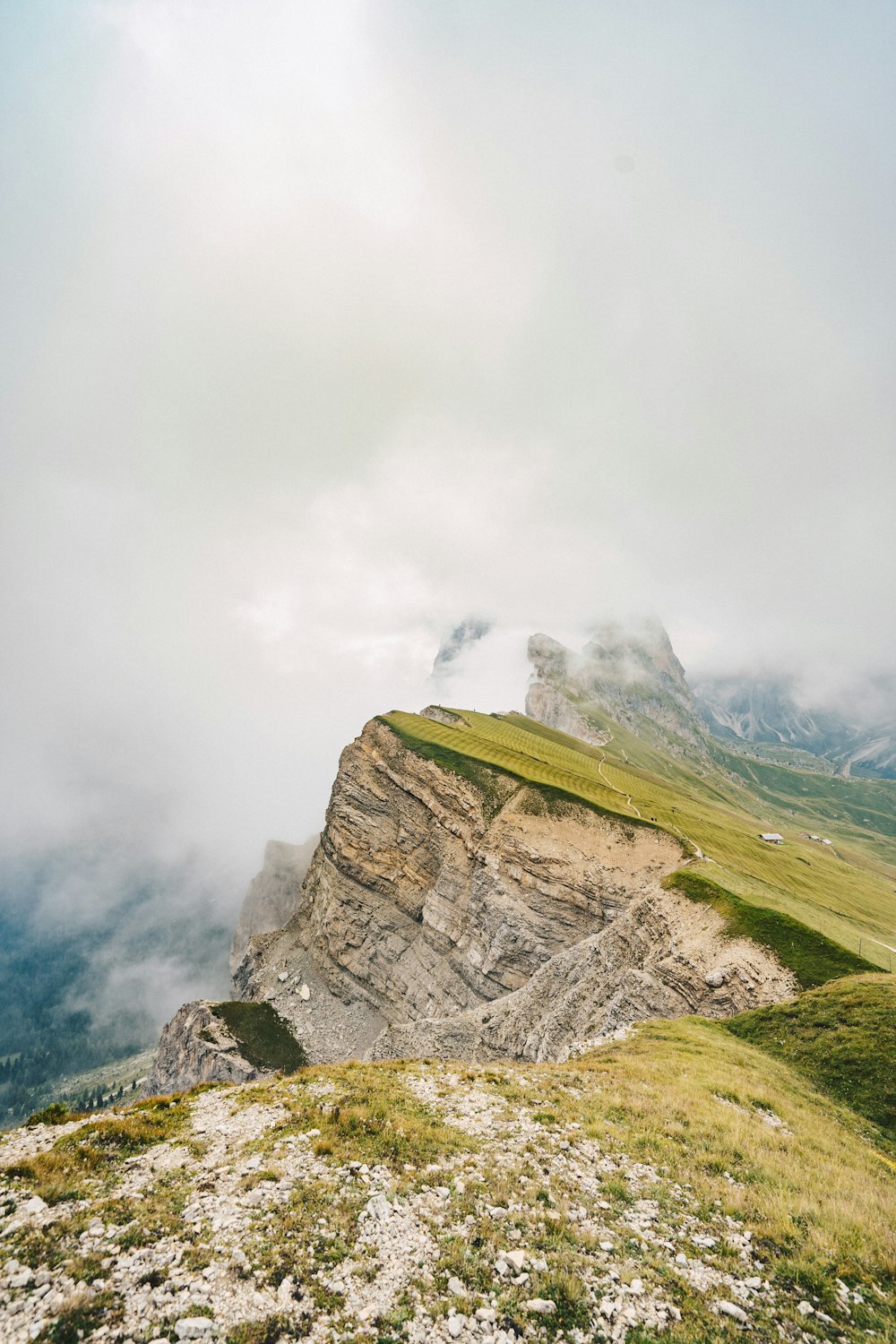 uma pessoa em pé no topo de uma montanha em um dia nublado