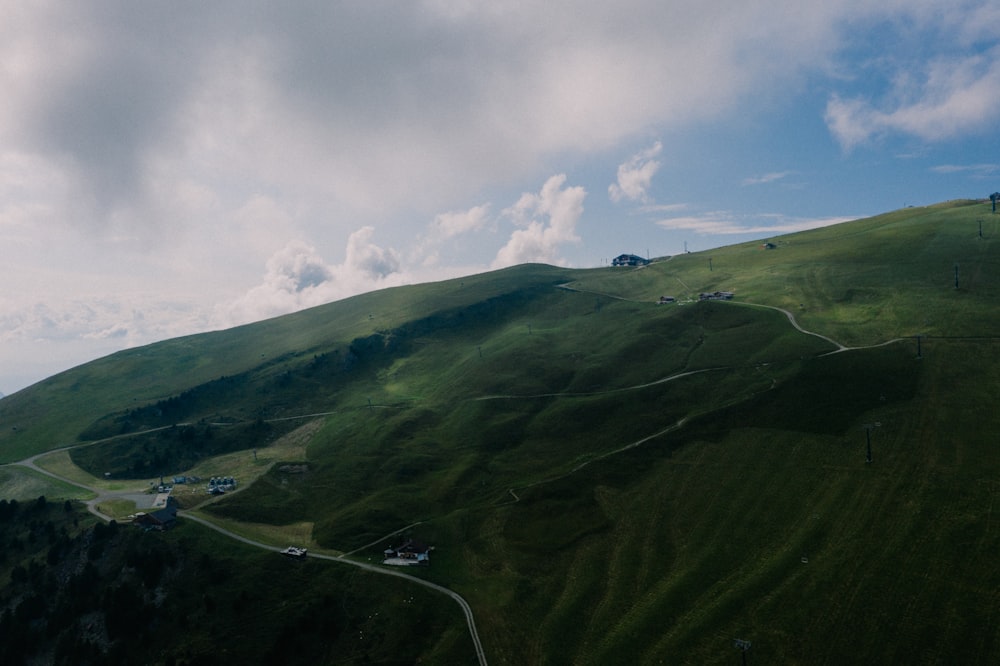 landscape photo of green mountains under white clouds during daytime