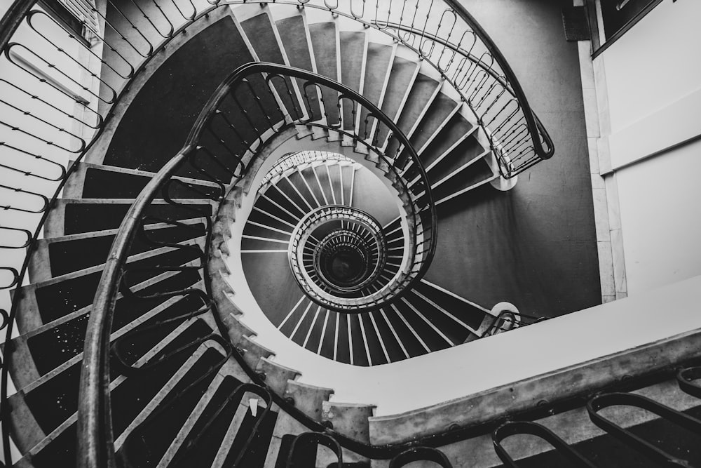 grayscale photography of spiral stair