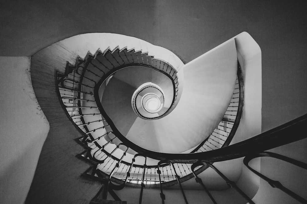 grayscale photography of spiral stairs