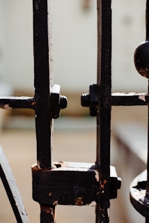 Close-up of a stainless steel gate with intricate welding details shining under natural light.
