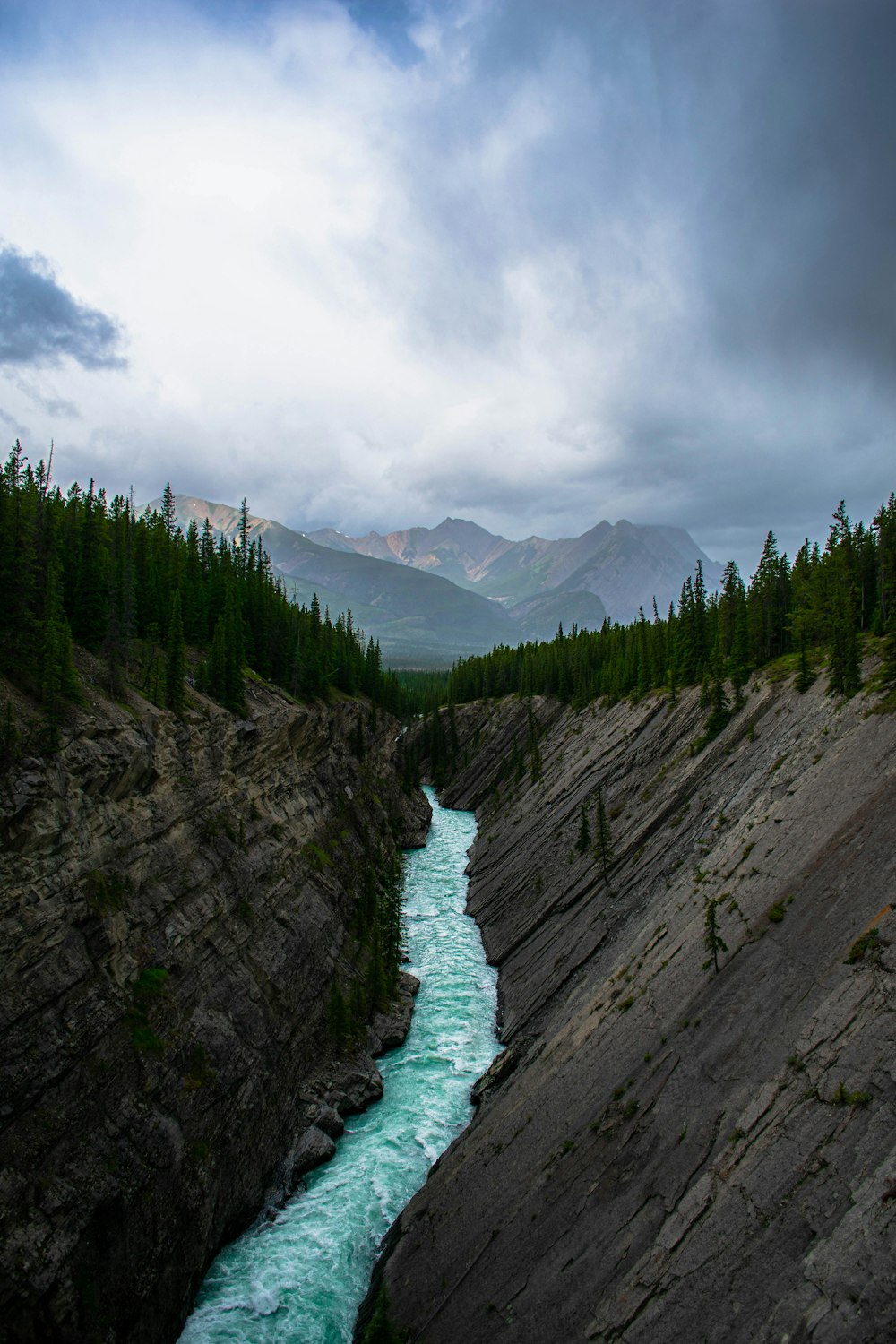 a river running through a valley surrounded by mountains