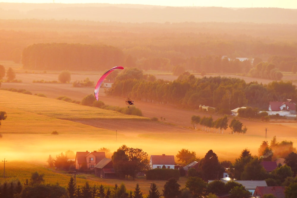 person riding paraglider at daytime