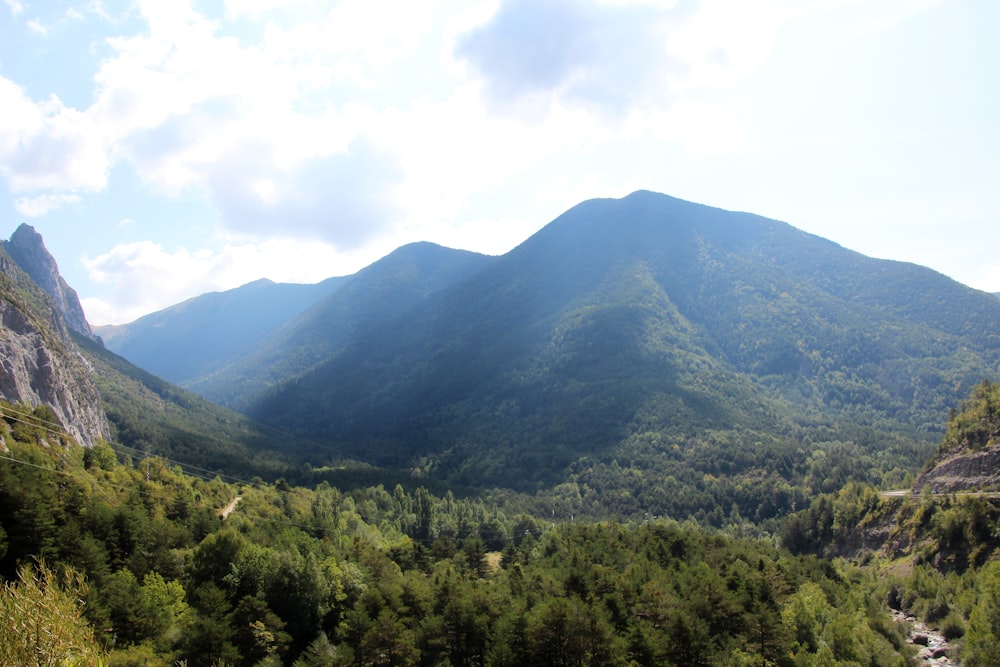 green and black mountains under white sky at daytime