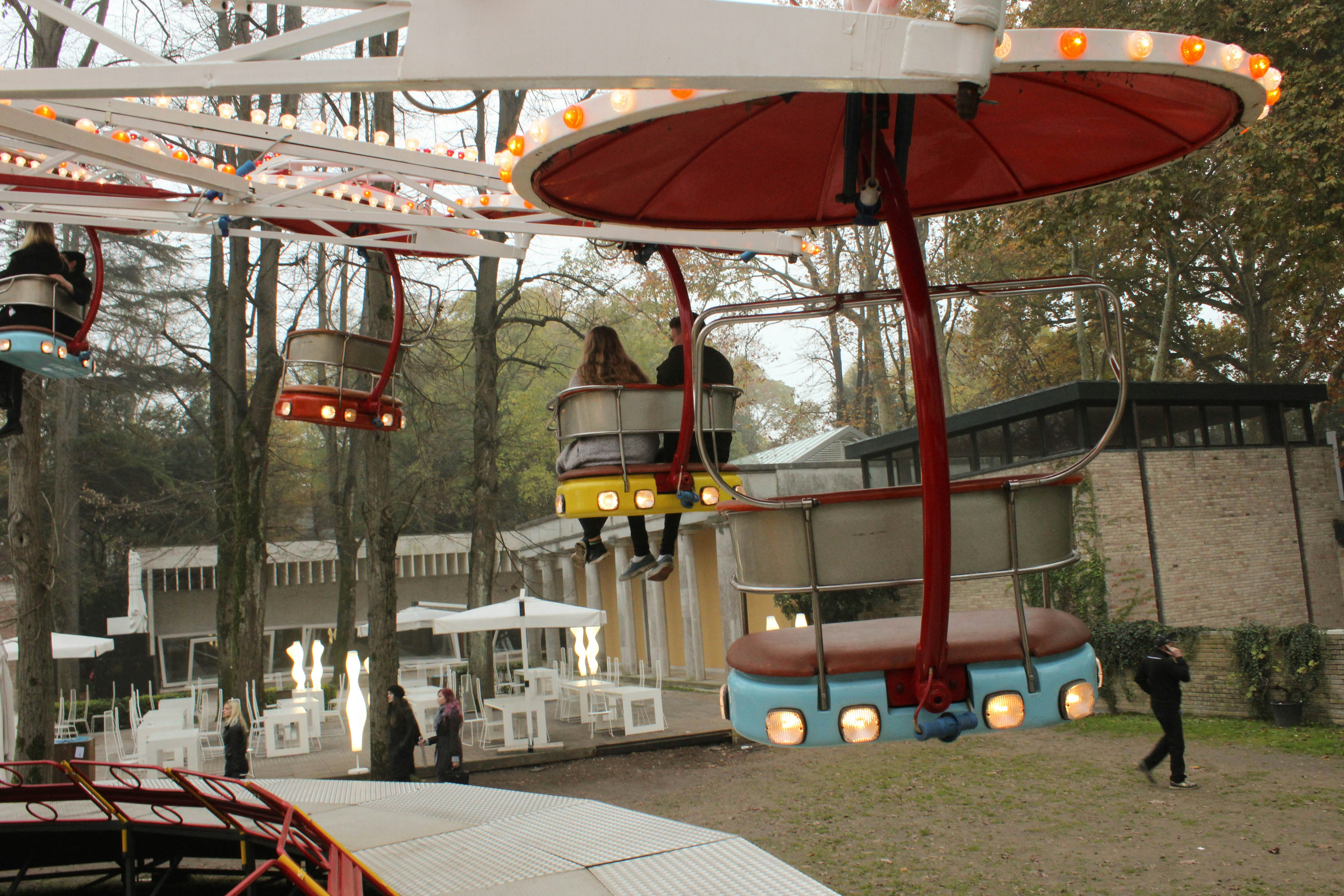 people in amusement park during daytime