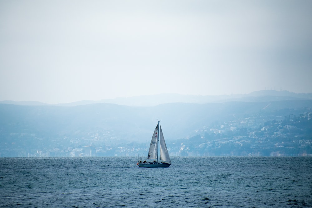 a sailboat in the middle of a body of water