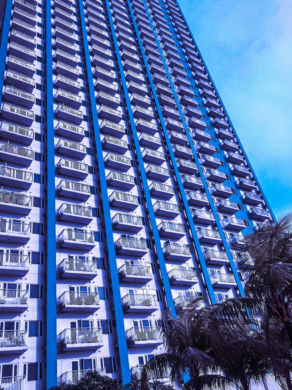 a tall building with balconies on the top of it